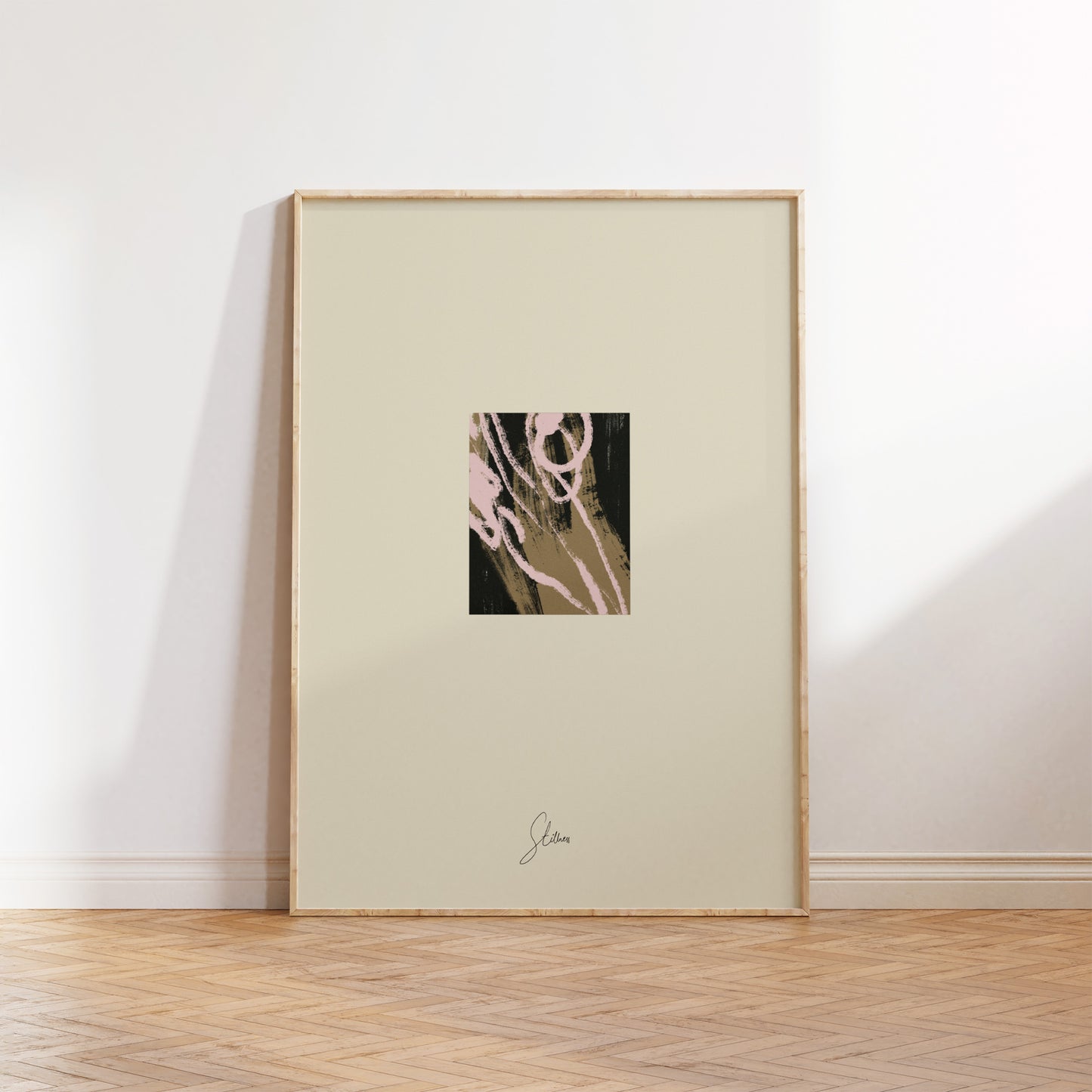 Framed abstract artwork on a white wall with wooden floor