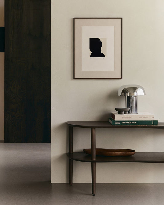 Modern interior with a dark wooden console table against a light wall, featuring a framed abstract art piece. artist anna pepe, forn studio, abstract painting, small art work, female abstract form