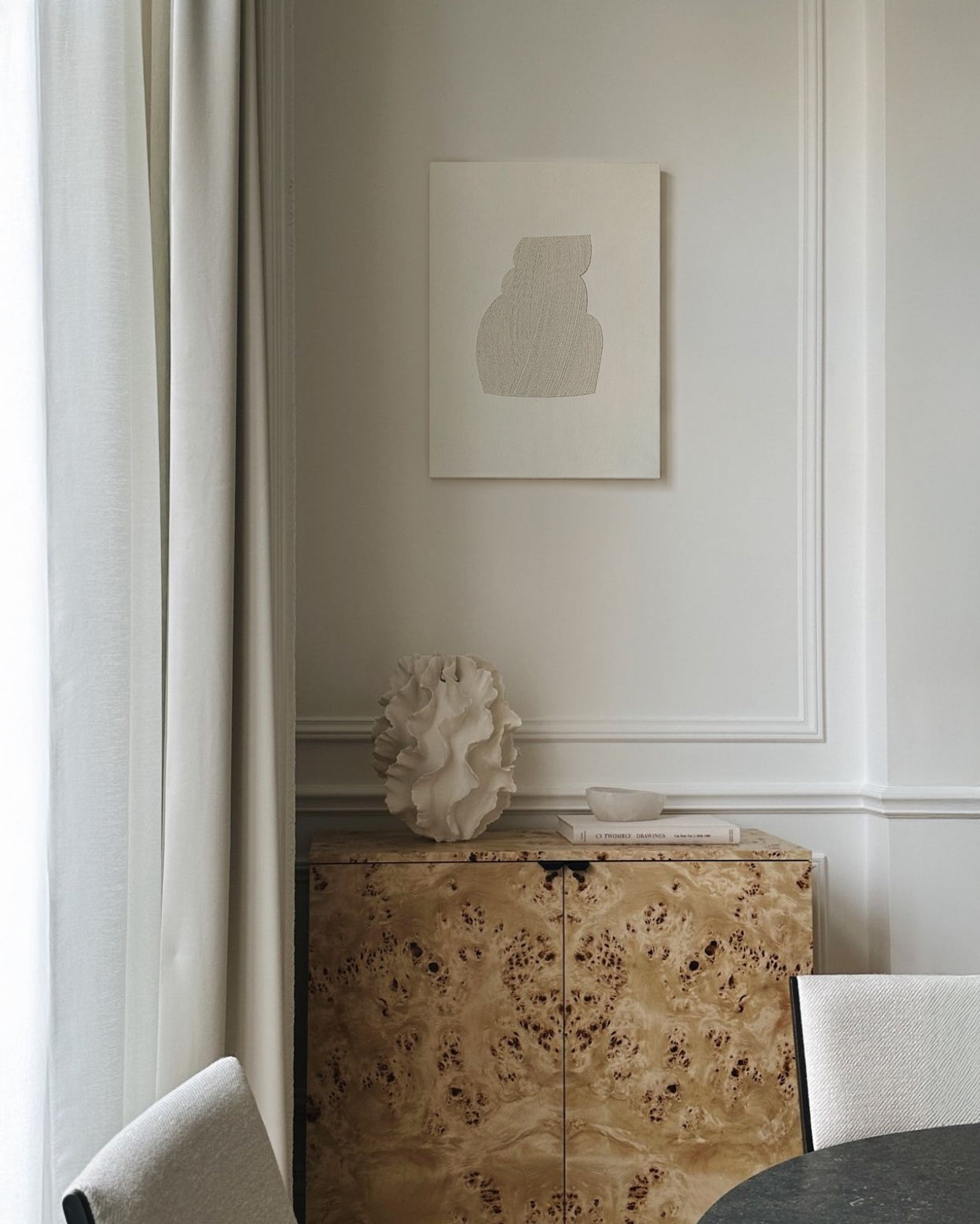 Decorative interior scene with a textured cabinet, sculpture, and framed artwork on a wall. artist anna pepe, forn studio, abstract painting, small art work, female abstract form