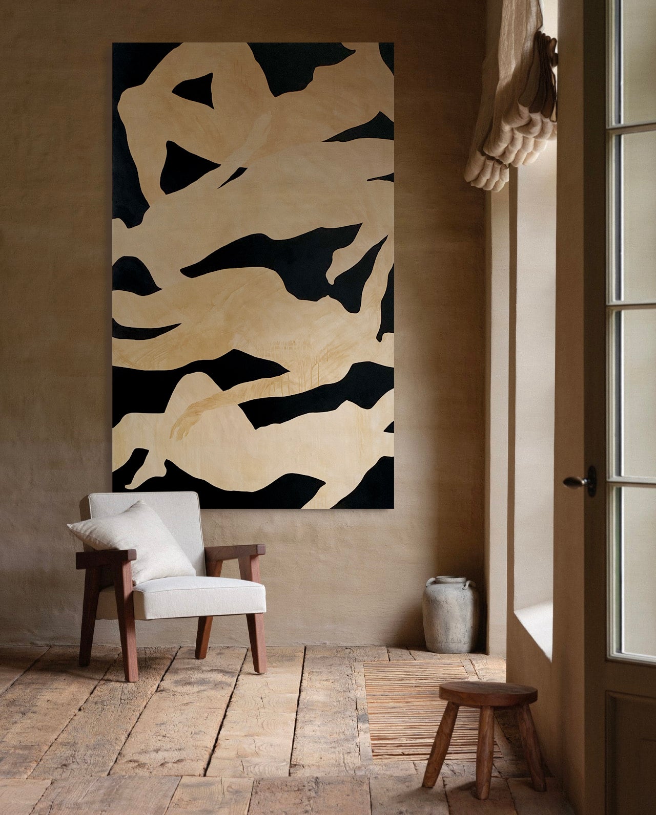 Abstract art piece by Anna Pepe on a wall in a room with a chair and stool.