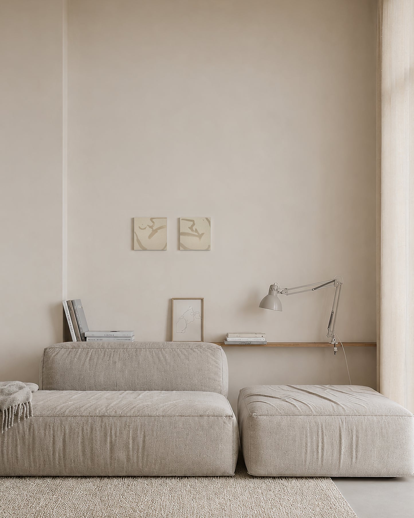 Beige sofa and ottoman in a minimalistic room with light-colored walls and a lamp. Anna Pepe, forn Studio, unprimed canvas, set of two, small format wall art