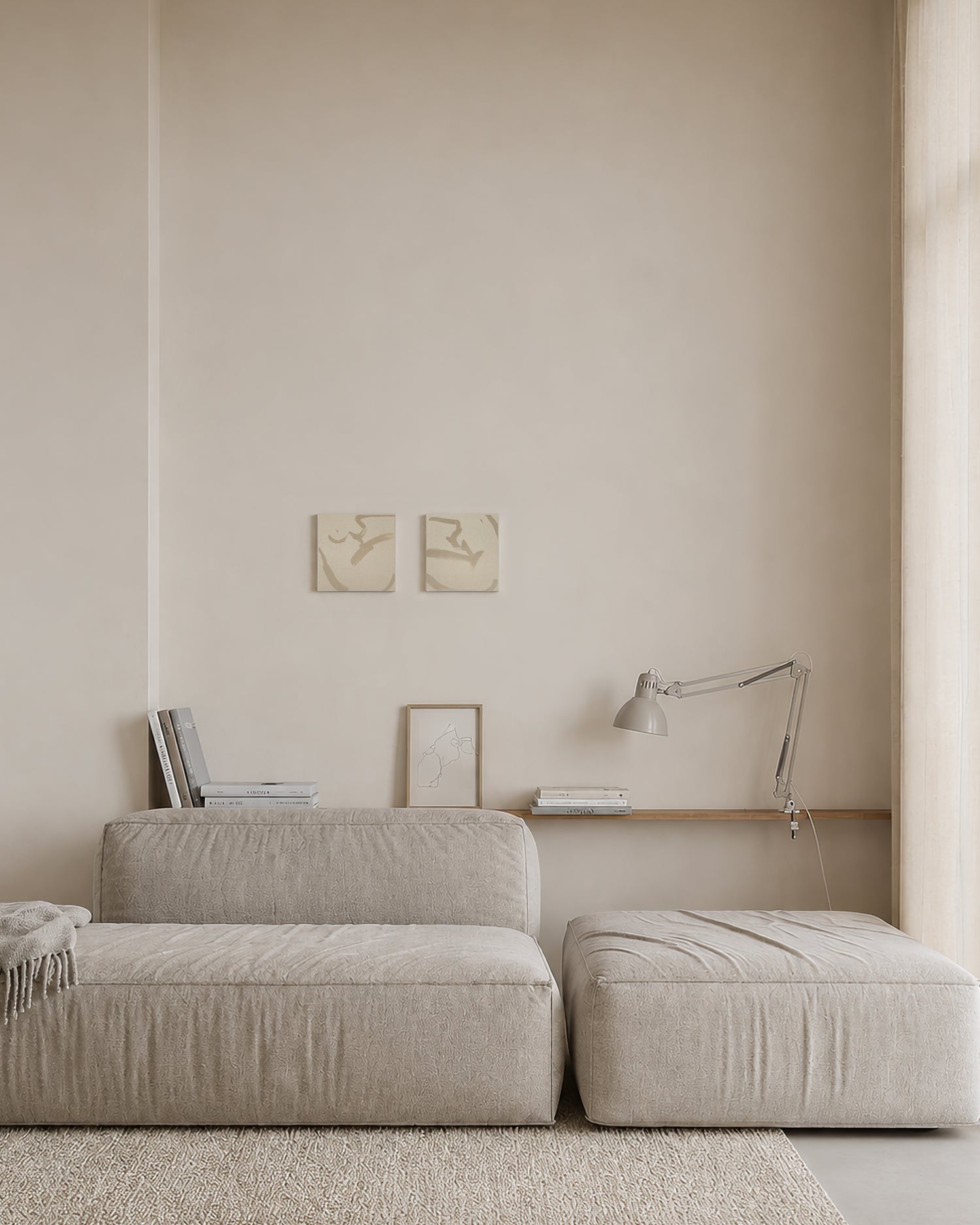 Beige sofa and ottoman in a minimalistic room with light-colored walls and a lamp. Anna Pepe, forn Studio, unprimed canvas, set of two, small format wall art