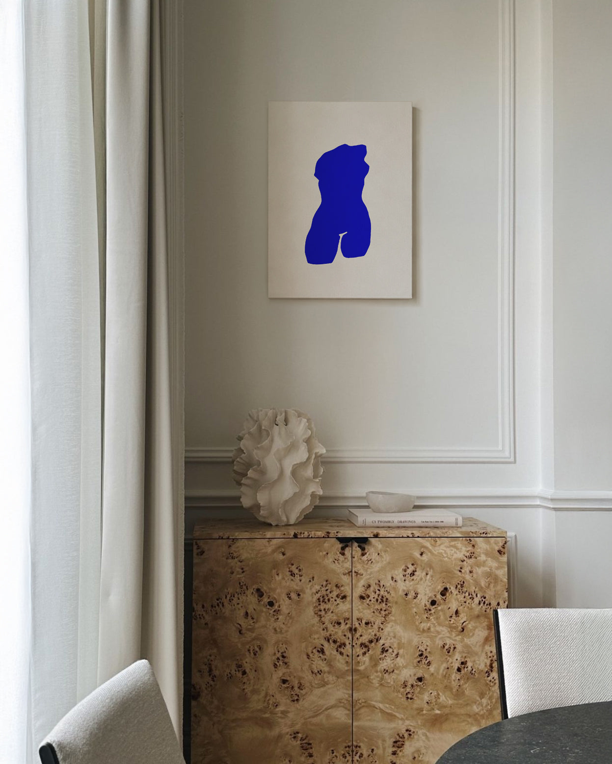Modern interior with a blue abstract sculpture on the wall above a decorative cabinet. artist anna pepe, forn studio, abstract painting, small art work, female abstract form